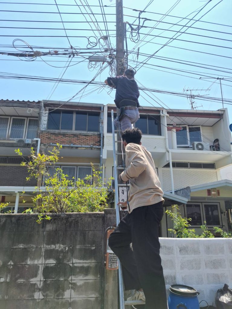 Two workers are fixing electrical cables