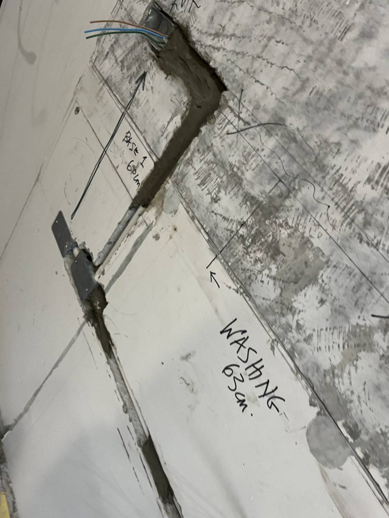 Electrical conduit installation on a wall prepared for wiring and outlet placement