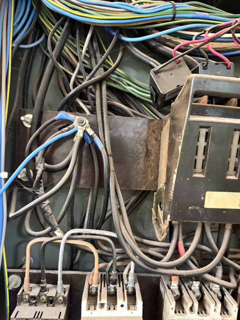 old electrical wiring inside a control cabinet